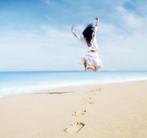 Woman with footprint enjoying freedom on beach